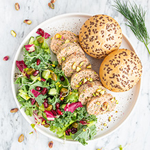 breakfast in a pesco-vegetarian box diet - salmon terrine with pistachios, salad with cucumber, capers and dill, wholegrain bun